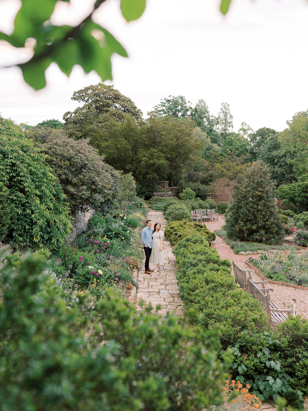 Couple posing in an editorial way at Bishop's Garden, one of the best engagement photo locations in DC.