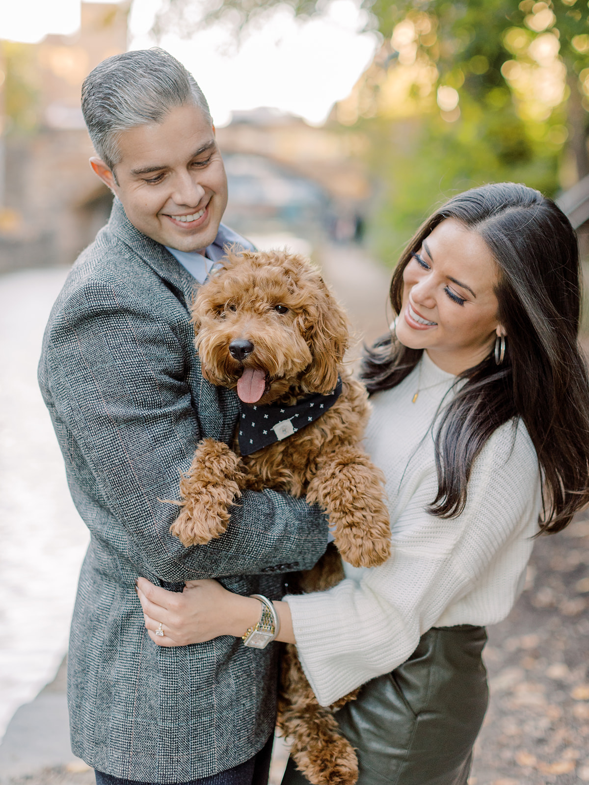 Couple posing with their dog at sunset in the C&O Canal in Georgetown.