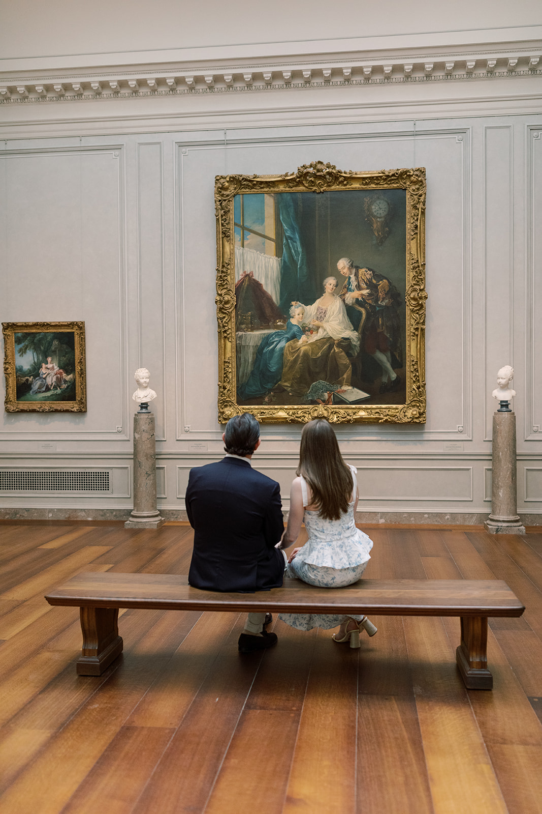 Couple enjoying art during their engagement session at the National Gallery of Art, one of the best engagement photo locations in DC.